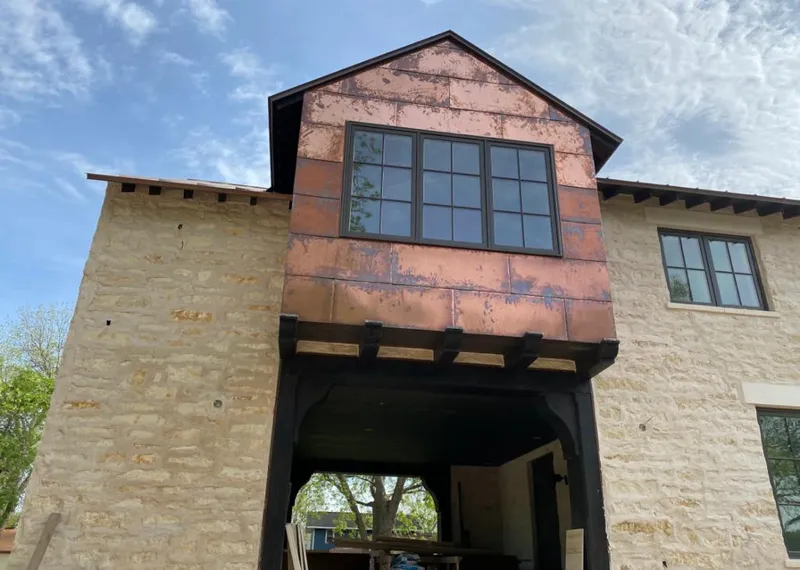Copper metal panel facade on a stone building for Skylight Installation in Nebraska City